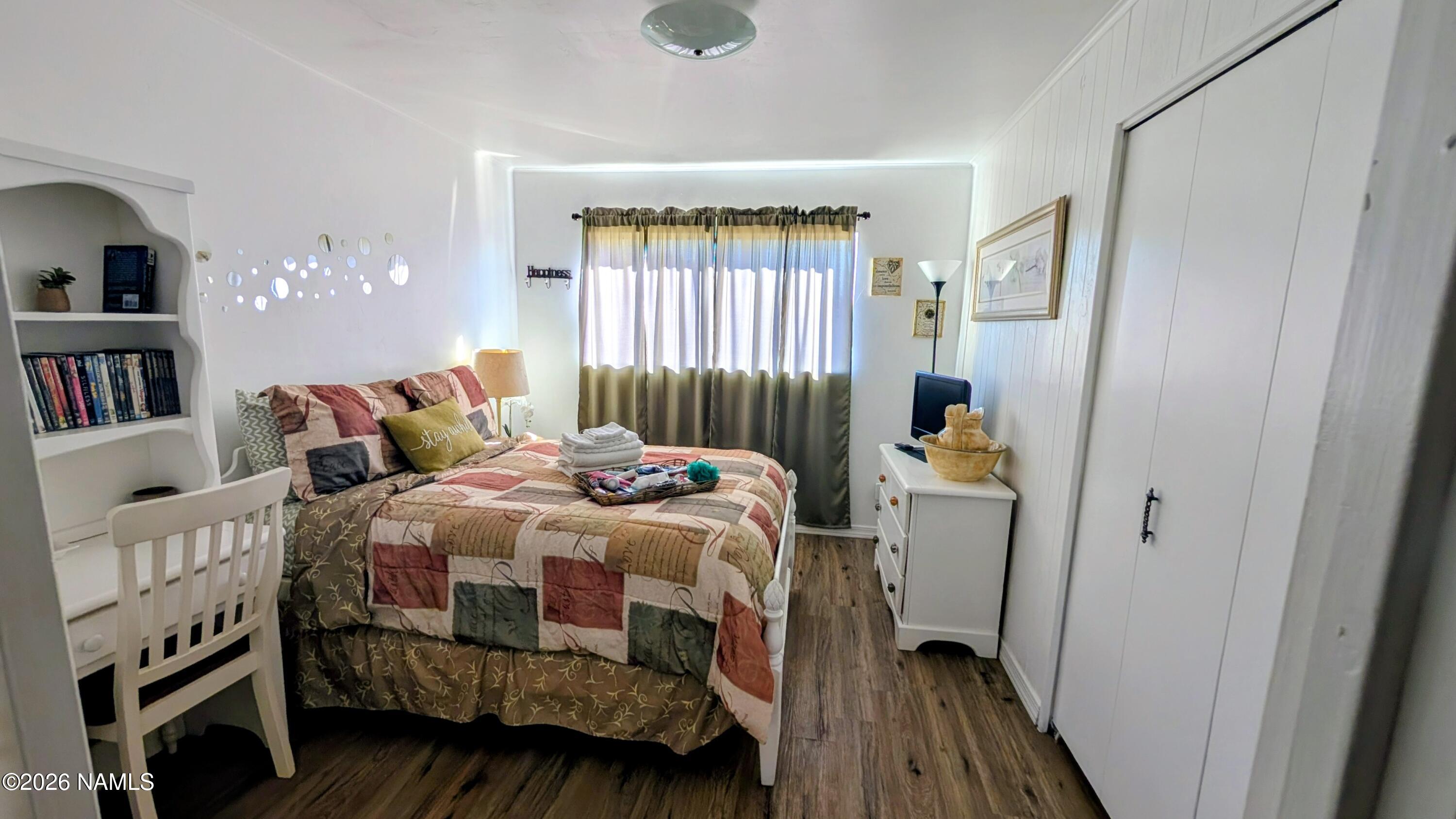 15702 Bonanza Loop Ehrenberg, AZ 85334 - Photo 11 of 13 a bedroom with a bed a window and book shelf