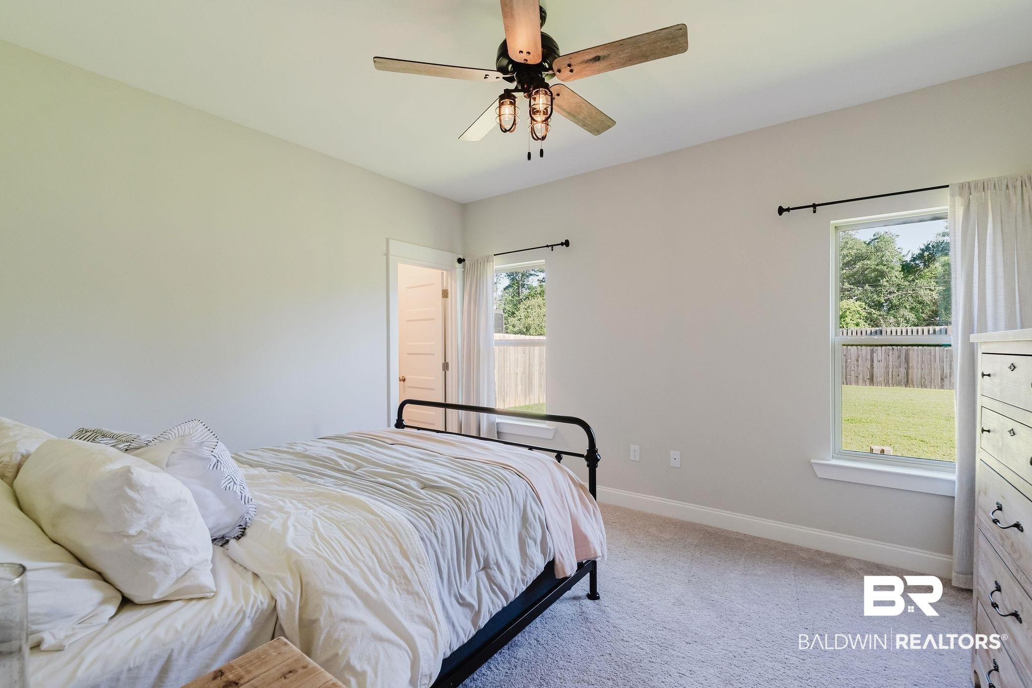 7872 Calverton Street Foley, AL 36535 - Photo 48 of 76 Carpeted room featuring a ceiling fan with light fixture, two windows, and light gray wall paint