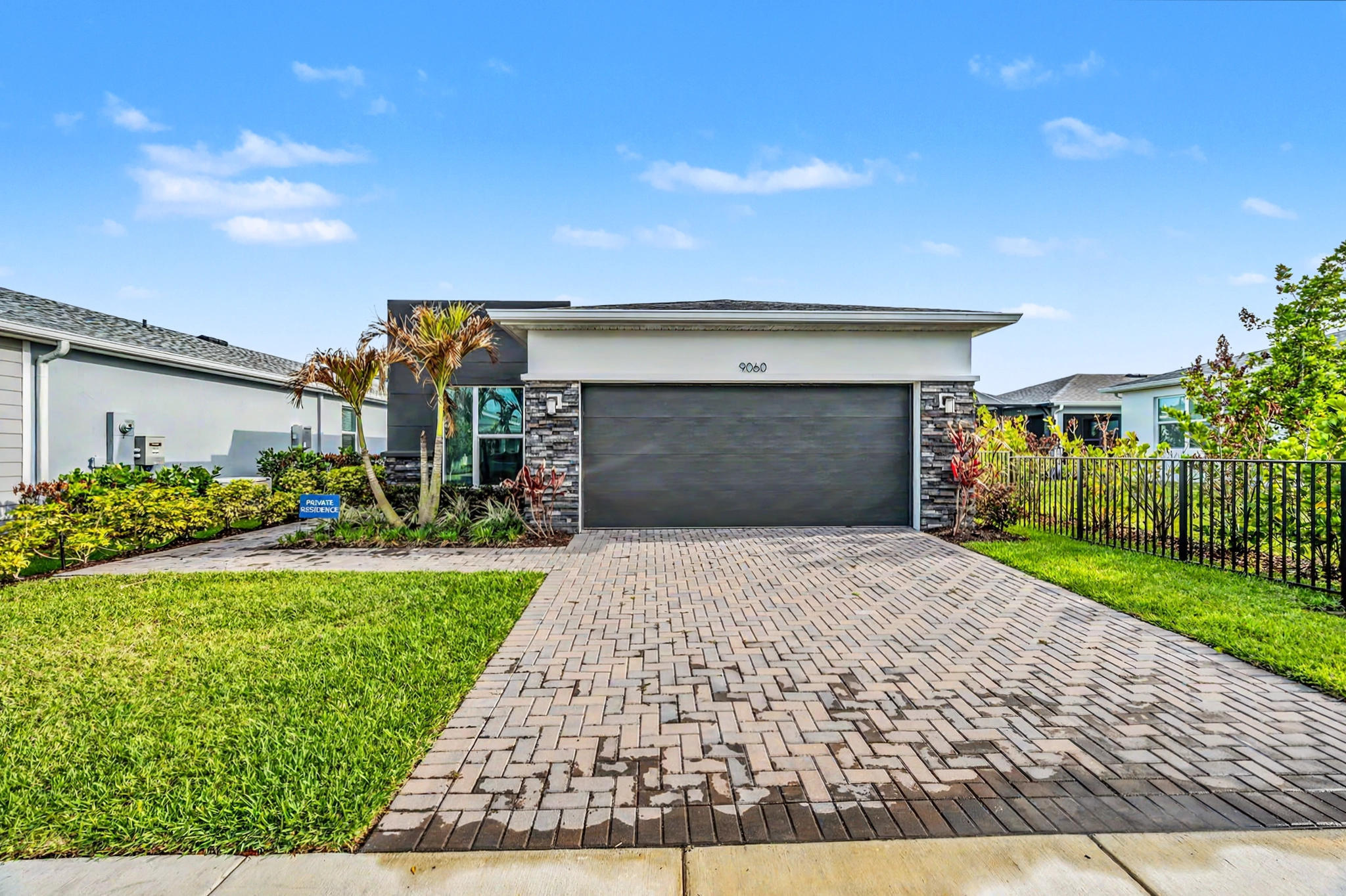9060 Remy Lane Port St. Lucie, FL 34987 - Photo 1 of 33 a front view of a house with a yard and garage