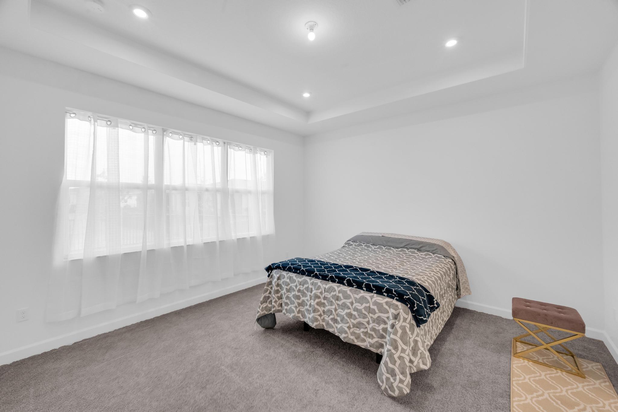 9060 Remy Lane Port St. Lucie, FL 34987 - Photo 21 of 33 a bedroom with a bed and a window