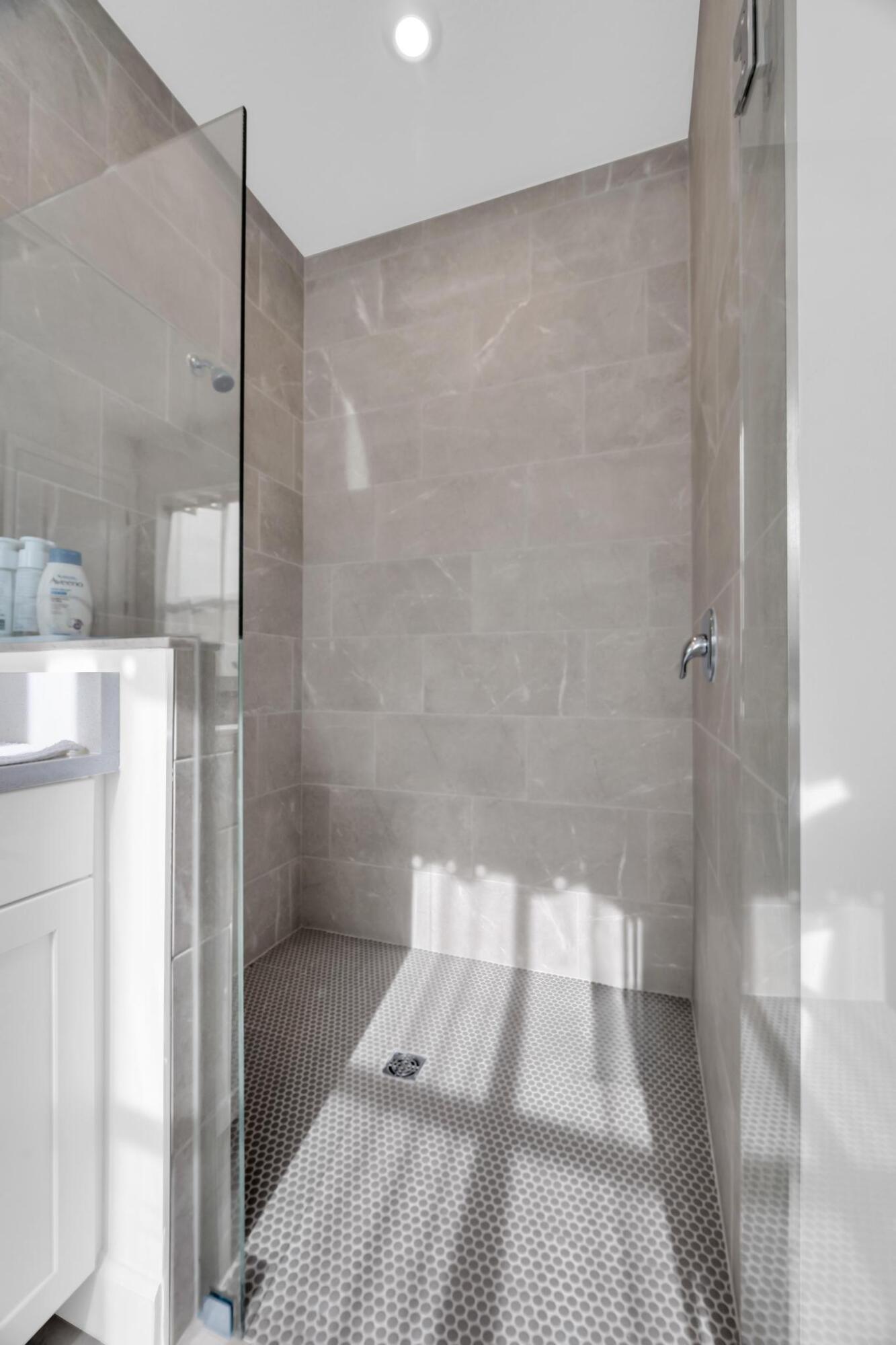 9060 Remy Lane Port St. Lucie, FL 34987 - Photo 24 of 33 a bathroom with a shower and a toilet