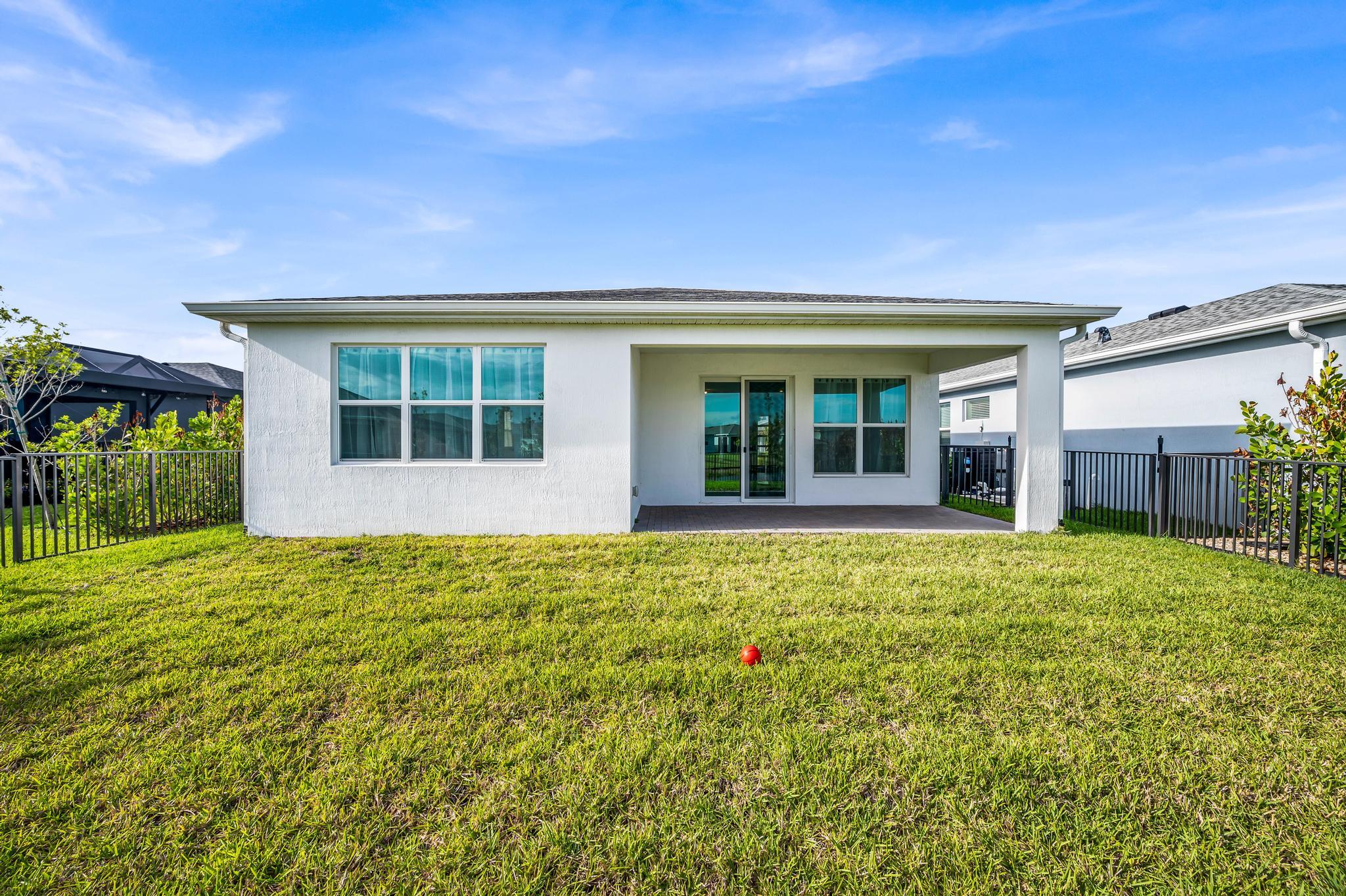 9060 Remy Lane Port St. Lucie, FL 34987 - Photo 31 of 33 front view of a house with a yard