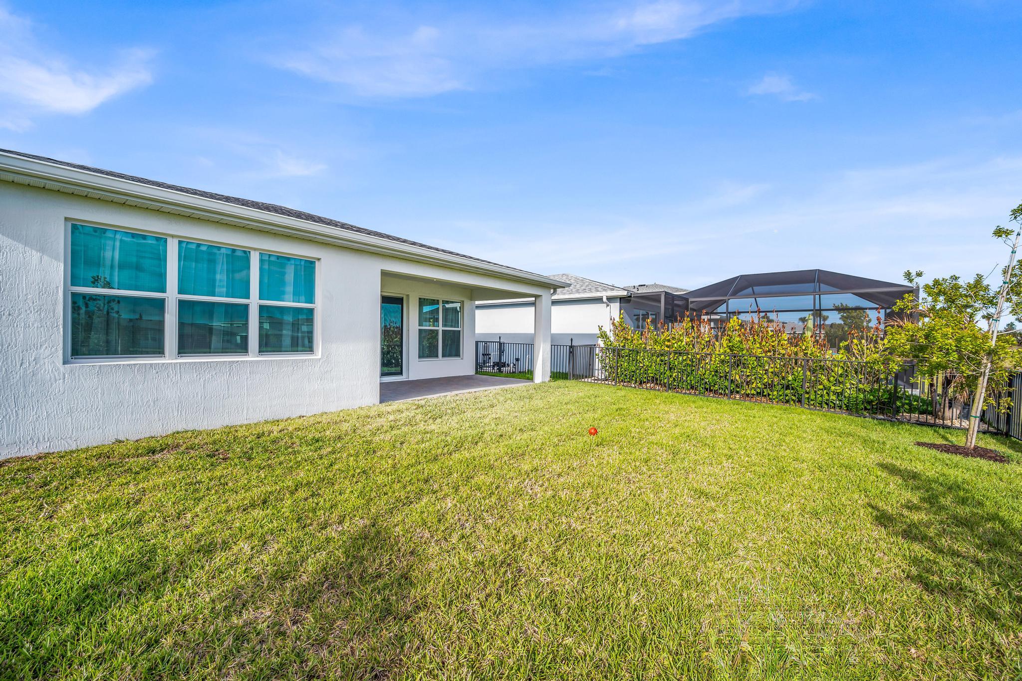 9060 Remy Lane Port St. Lucie, FL 34987 - Photo 33 of 33 a front view of a house with a garden