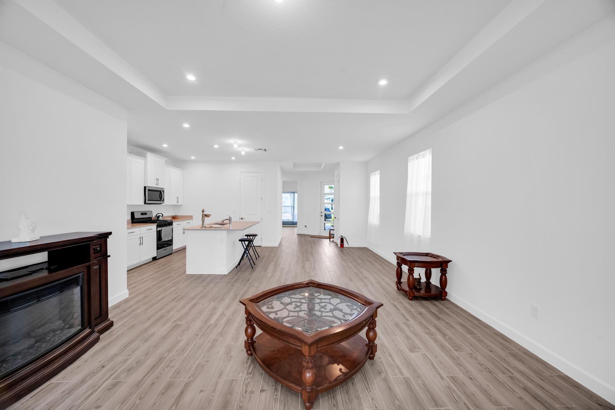 9060 Remy Lane Port St. Lucie, FL 34987 - Photo 6 of 33 a living room with furniture and a wooden floor