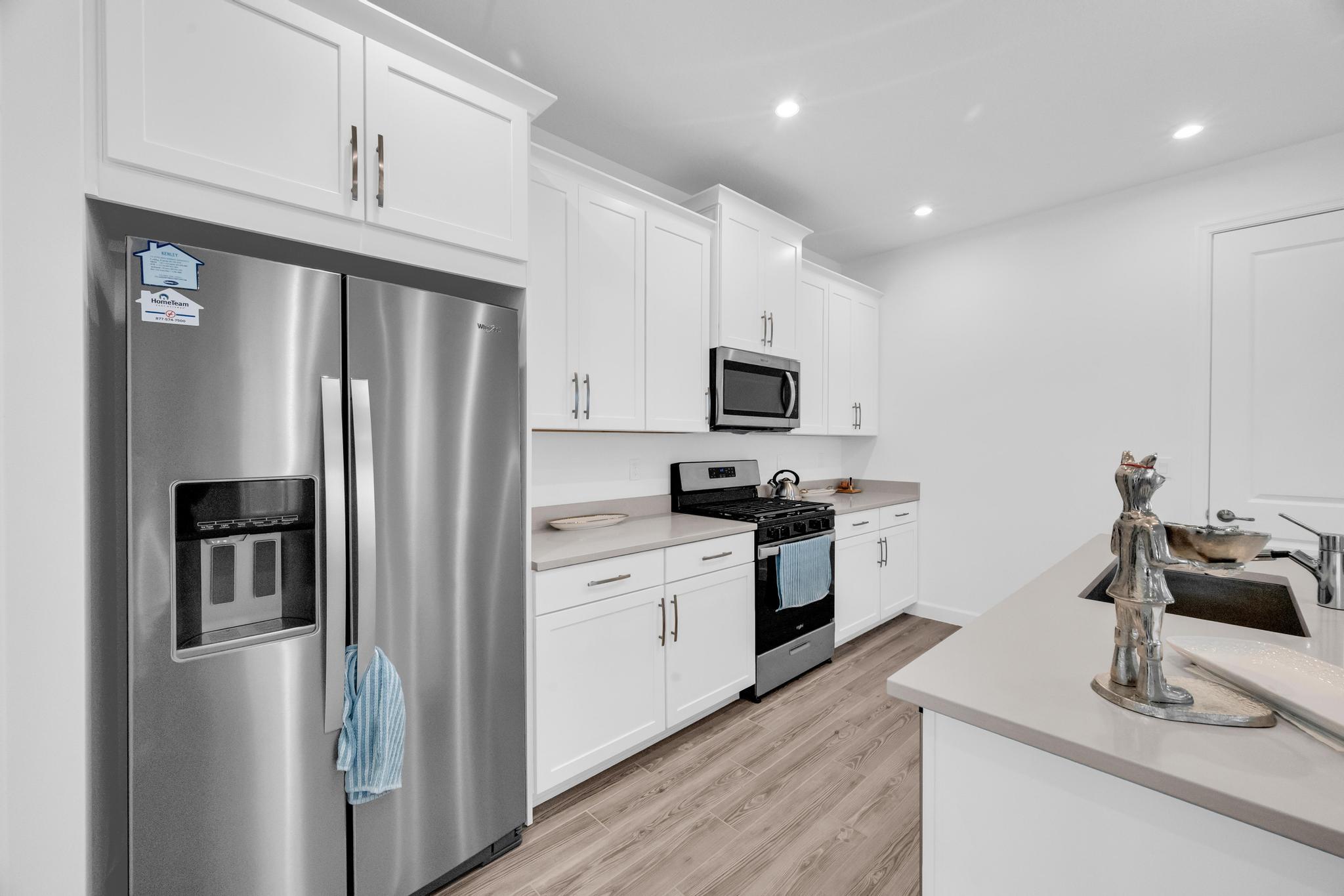 9060 Remy Lane Port St. Lucie, FL 34987 - Photo 10 of 33 a kitchen with stainless steel appliances a refrigerator sink and microwave