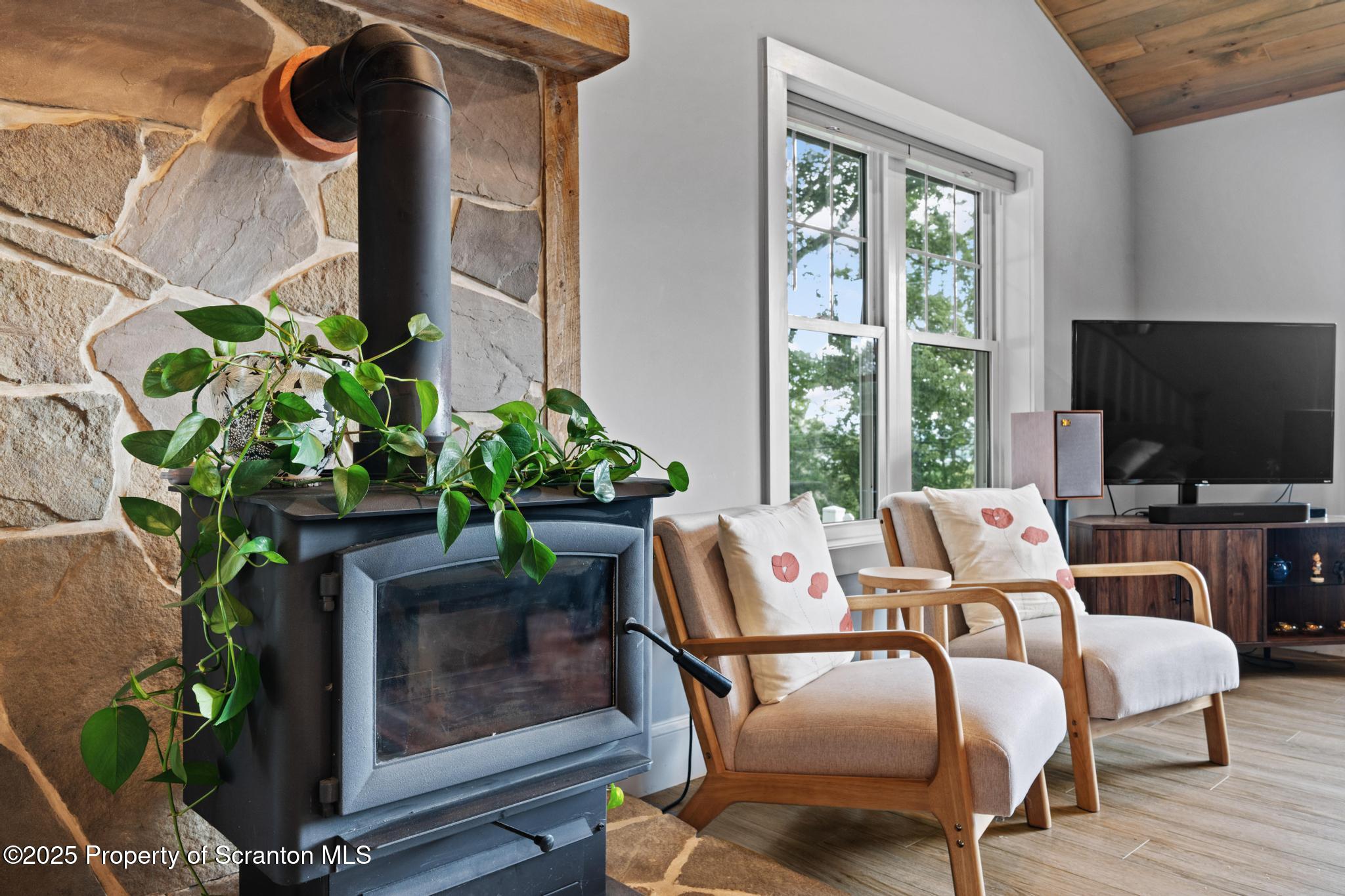 300 Gumbletown Road Paupack, PA 18451 - Photo 14 of 46 a living room with furniture a flat screen tv and a fireplace