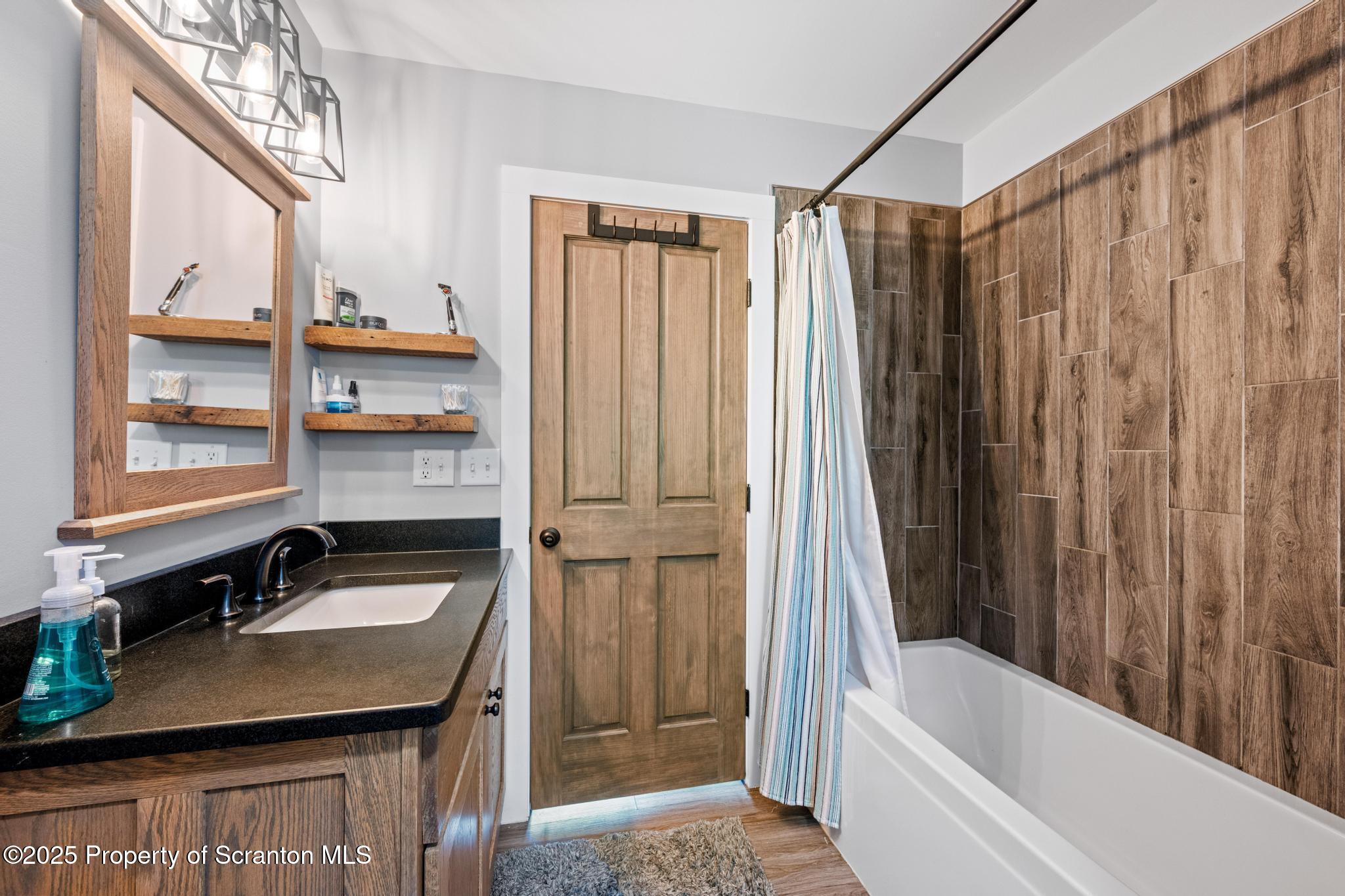300 Gumbletown Road Paupack, PA 18451 - Photo 17 of 46 a bathroom with a sink a bathtub and a shower