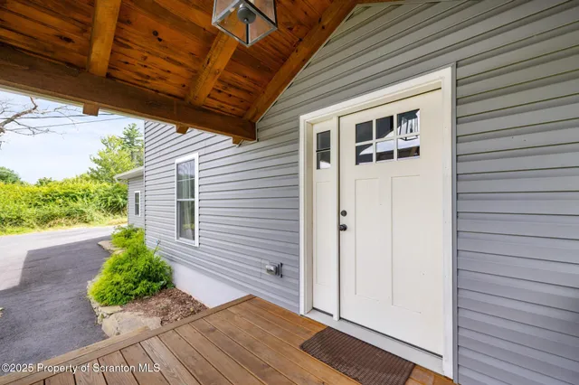 a view of a porch with wooden floor