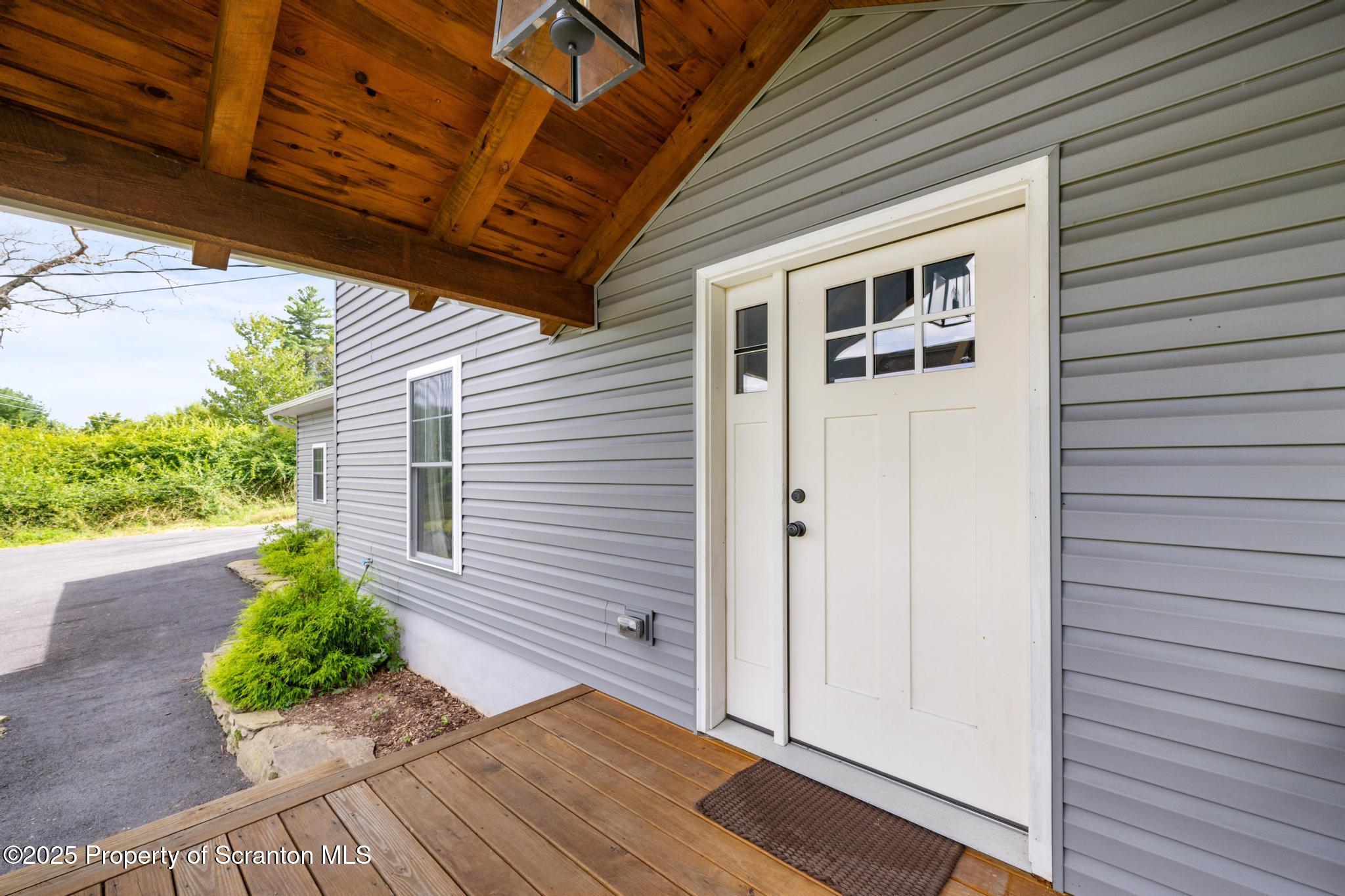 300 Gumbletown Road Paupack, PA 18451 - Photo 2 of 46 a view of a porch with wooden floor