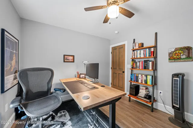 a work room with furniture and a book shelf