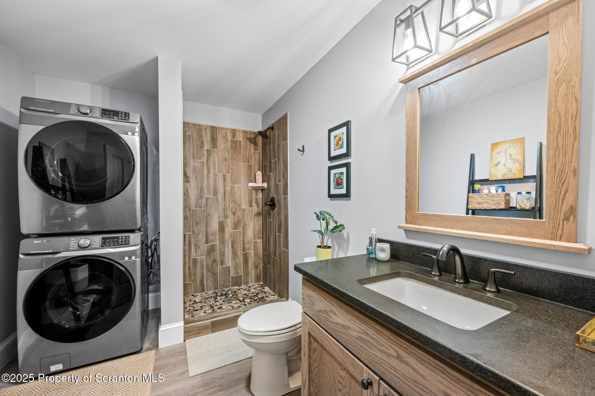 300 Gumbletown Road Paupack, PA 18451 - Photo 23 of 46 a bathroom with a granite countertop toilet a sink and a mirror