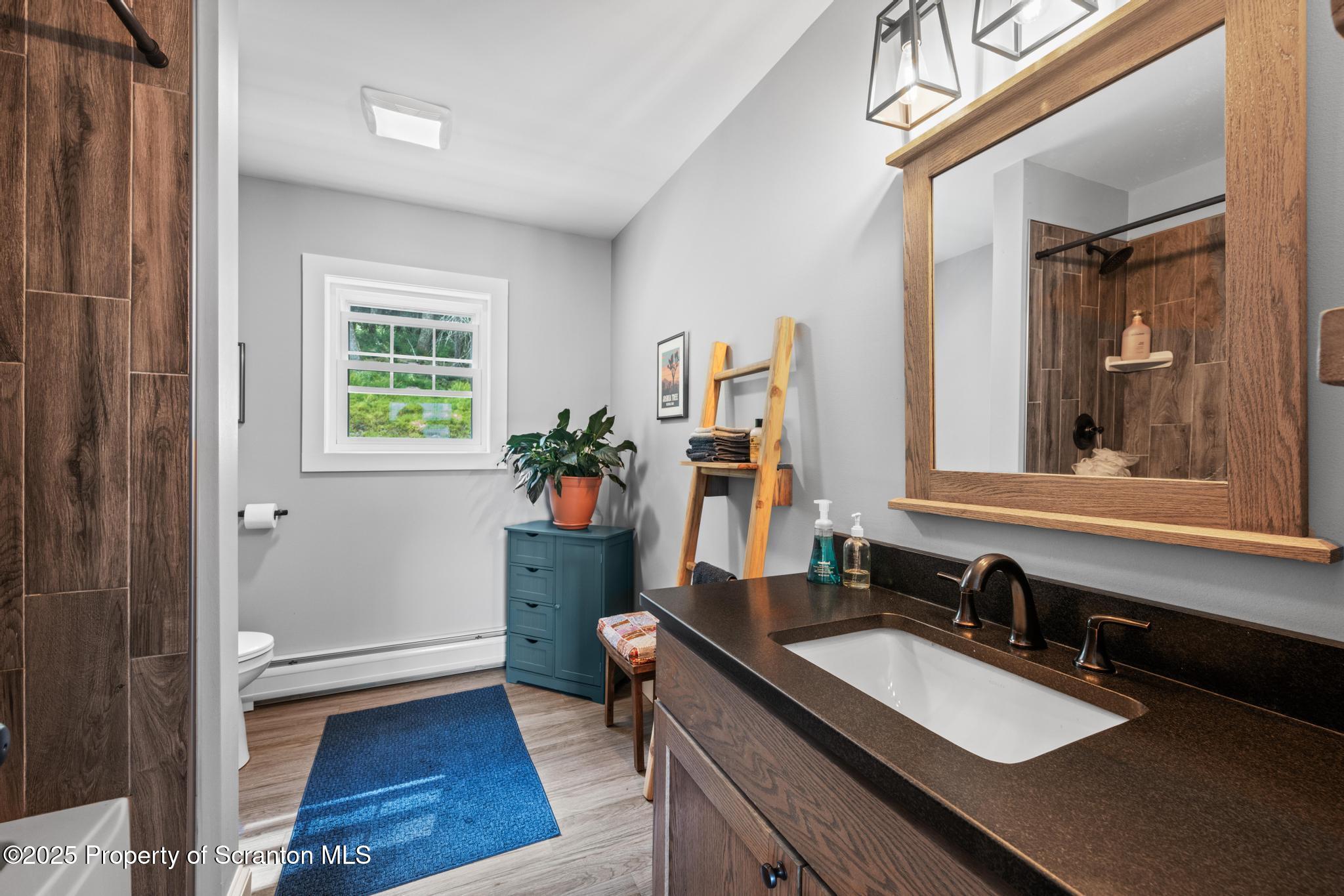 300 Gumbletown Road Paupack, PA 18451 - Photo 26 of 46 a bathroom with a sink and a mirror