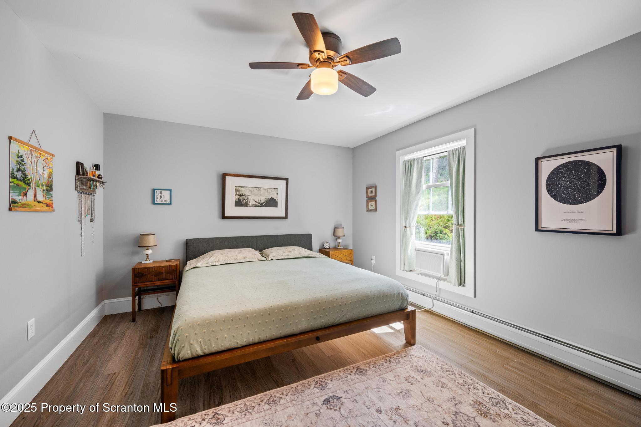 300 Gumbletown Road Paupack, PA 18451 - Photo 28 of 46 a bedroom with a bed and a chandelier