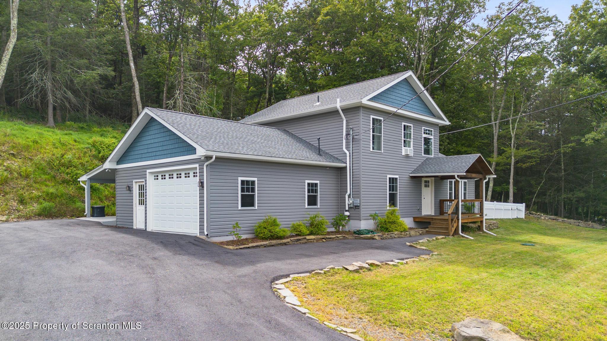 300 Gumbletown Road Paupack, PA 18451 - Photo 37 of 46 a front view of house with yard and trees in the background