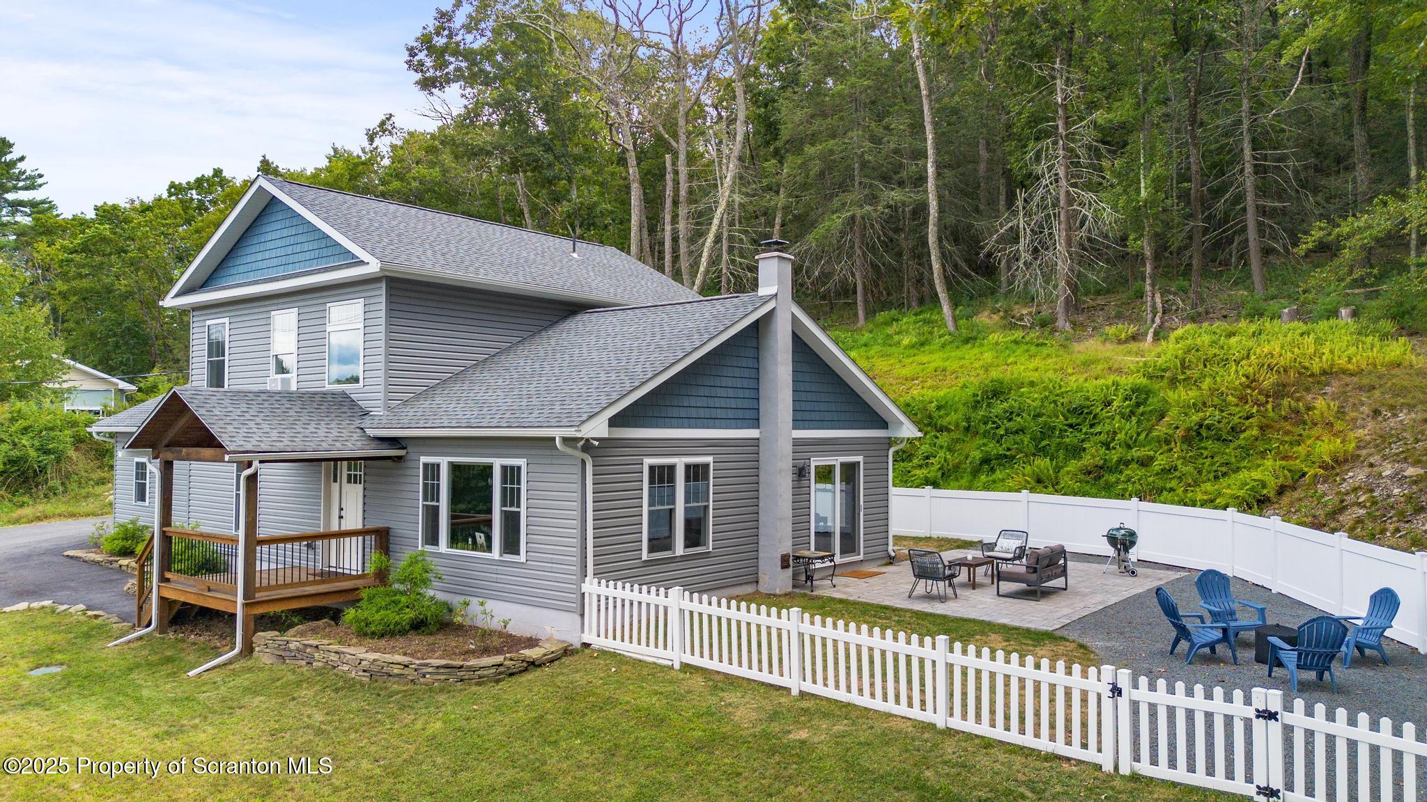 300 Gumbletown Road Paupack, PA 18451 - Photo 38 of 46 a view of house with backyard outdoor seating and green space