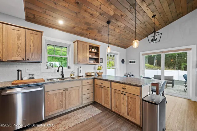 a kitchen with sink stove and cabinets
