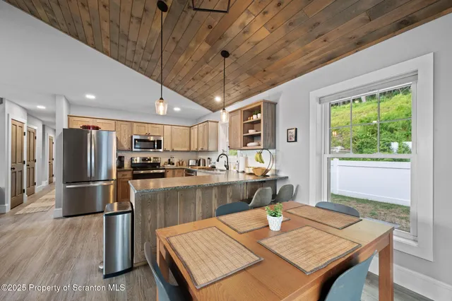 a large kitchen with a table and chairs