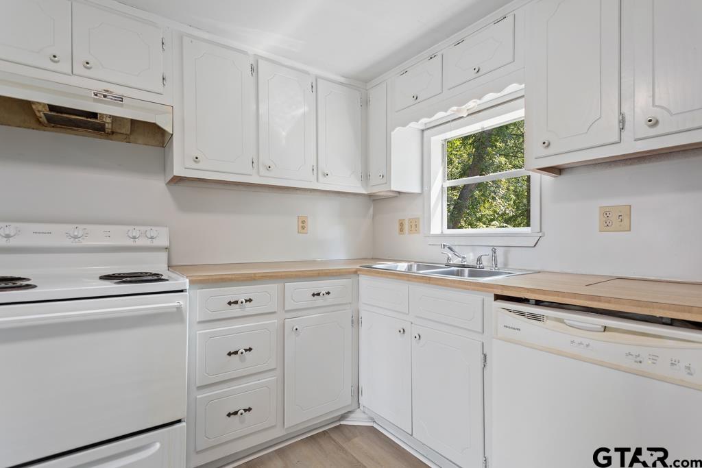 210 Cooper Street Lindale, TX 75771 - Photo 12 of 23 a kitchen with white cabinets and white appliances