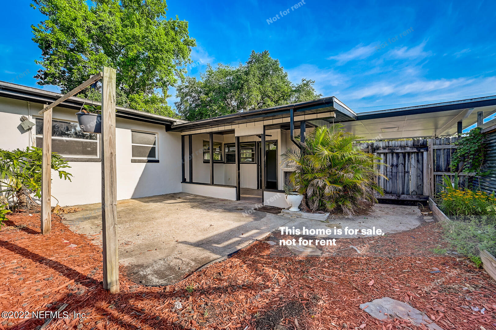 10918 Java Drive Jacksonville, FL 32246 - Photo 15 of 25 a view of a patio with table and chairs under an umbrella with large tree