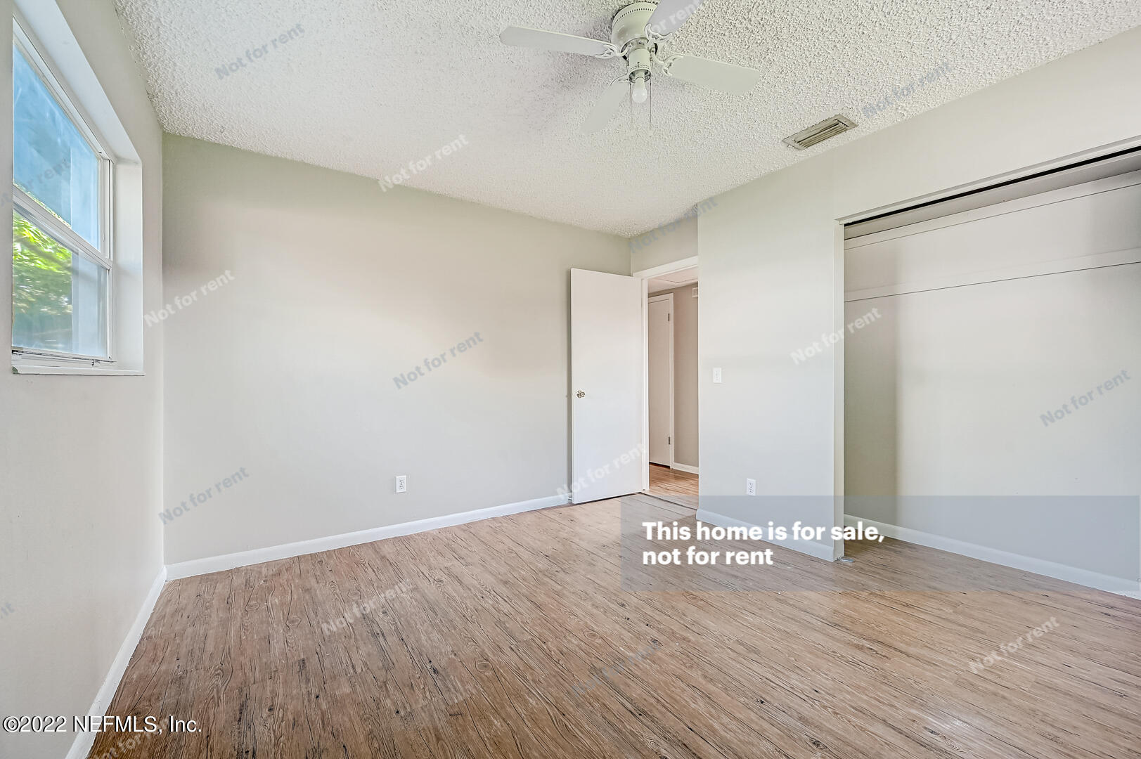 10918 Java Drive Jacksonville, FL 32246 - Photo 25 of 25 an empty room with wooden floor and windows