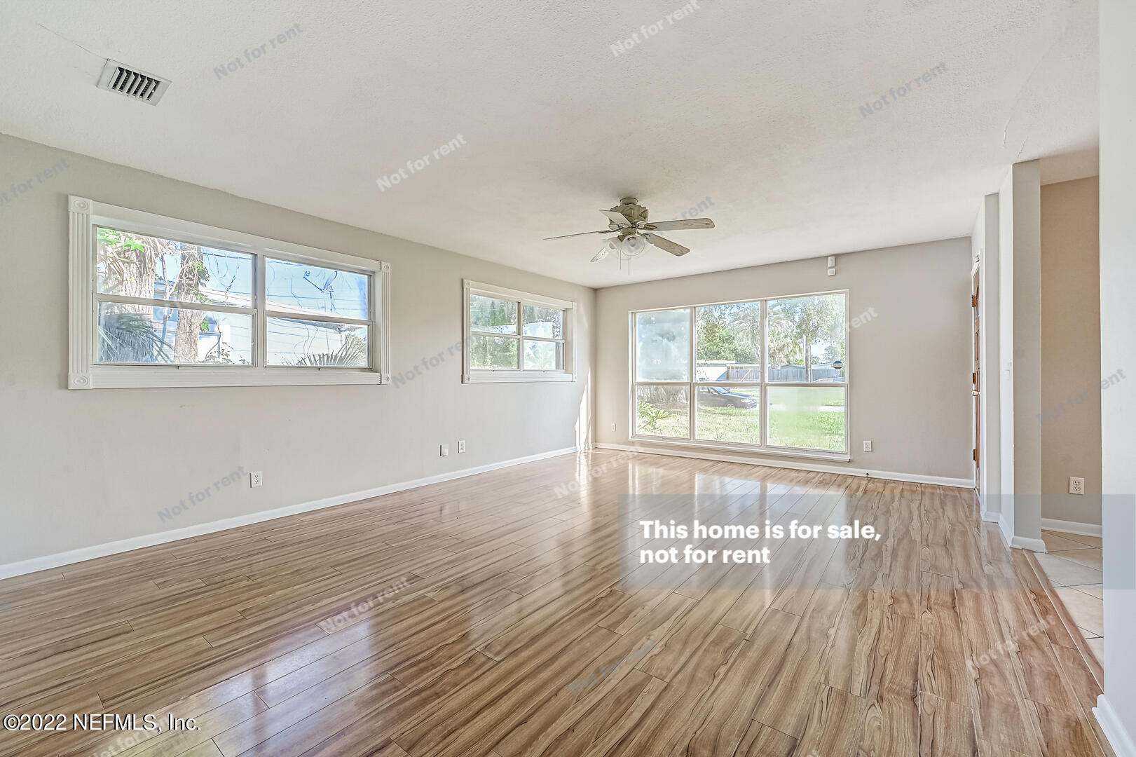 10918 Java Drive Jacksonville, FL 32246 - Photo 6 of 25 a view of an empty room with wooden floor and a window