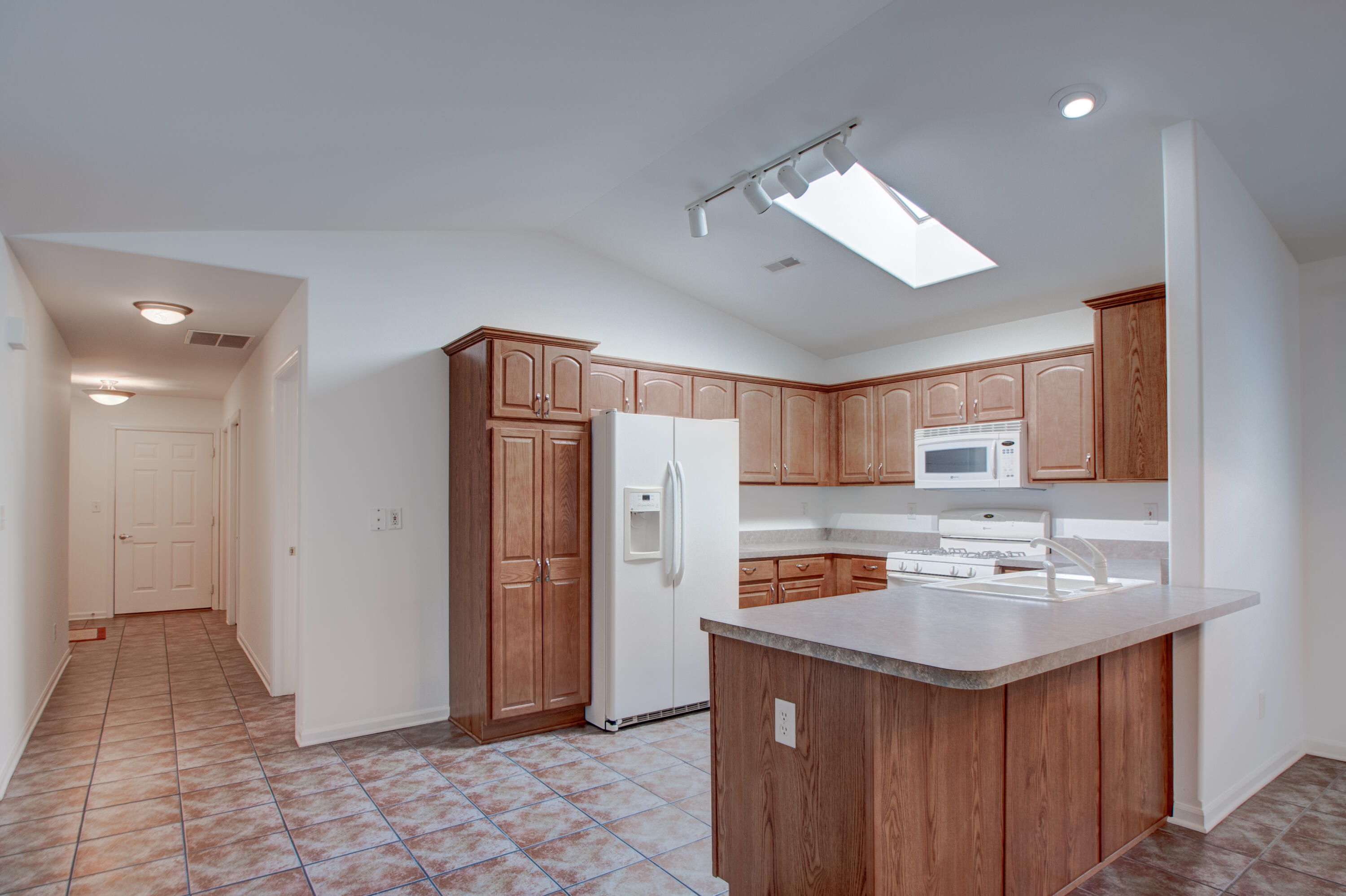 10677 Keystone Lane Crown Point, IN 46307 - Photo 11 of 33 a kitchen with refrigerator cabinets and a sink
