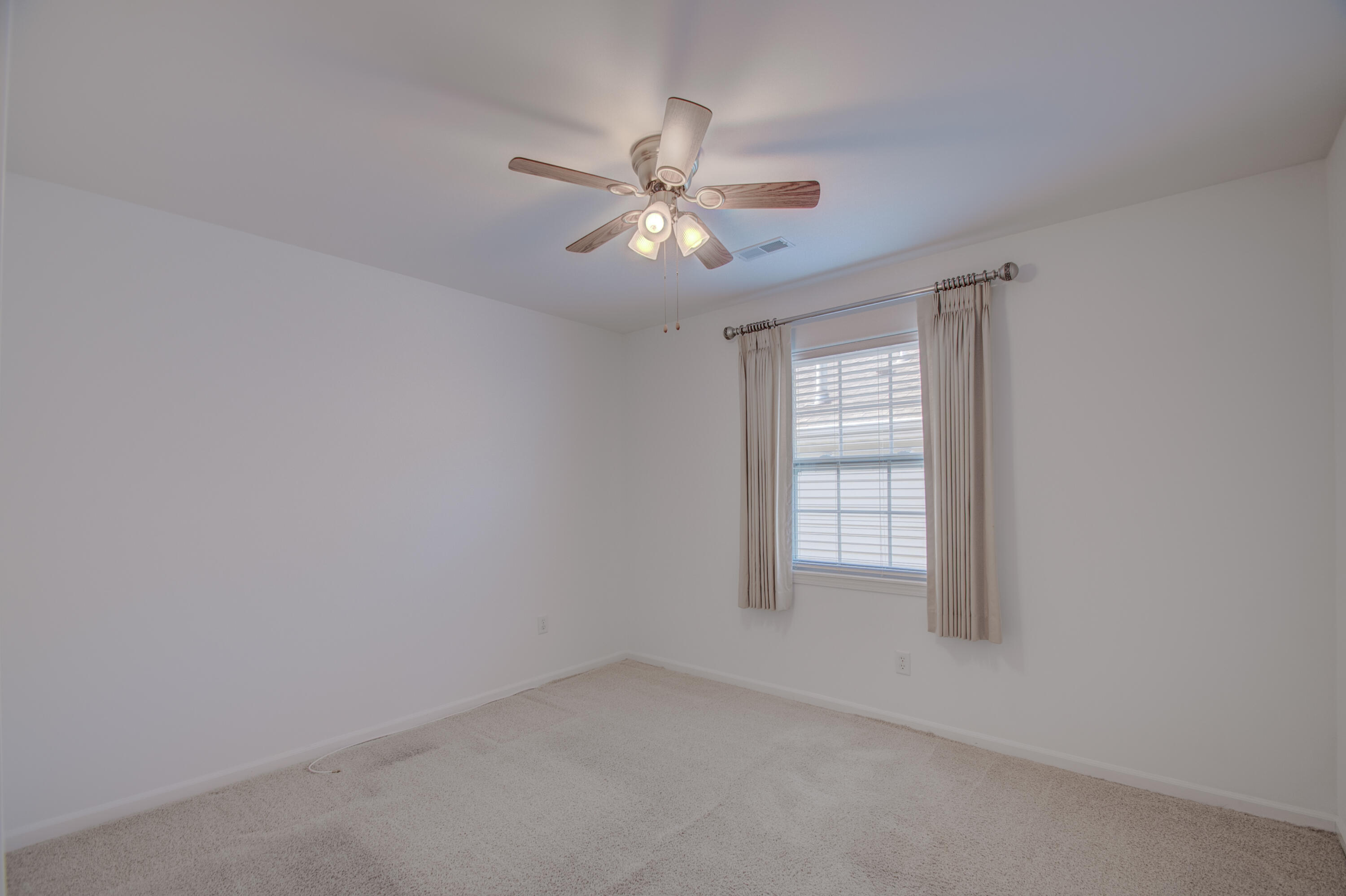 10677 Keystone Lane Crown Point, IN 46307 - Photo 20 of 33 an empty room with windows and fan