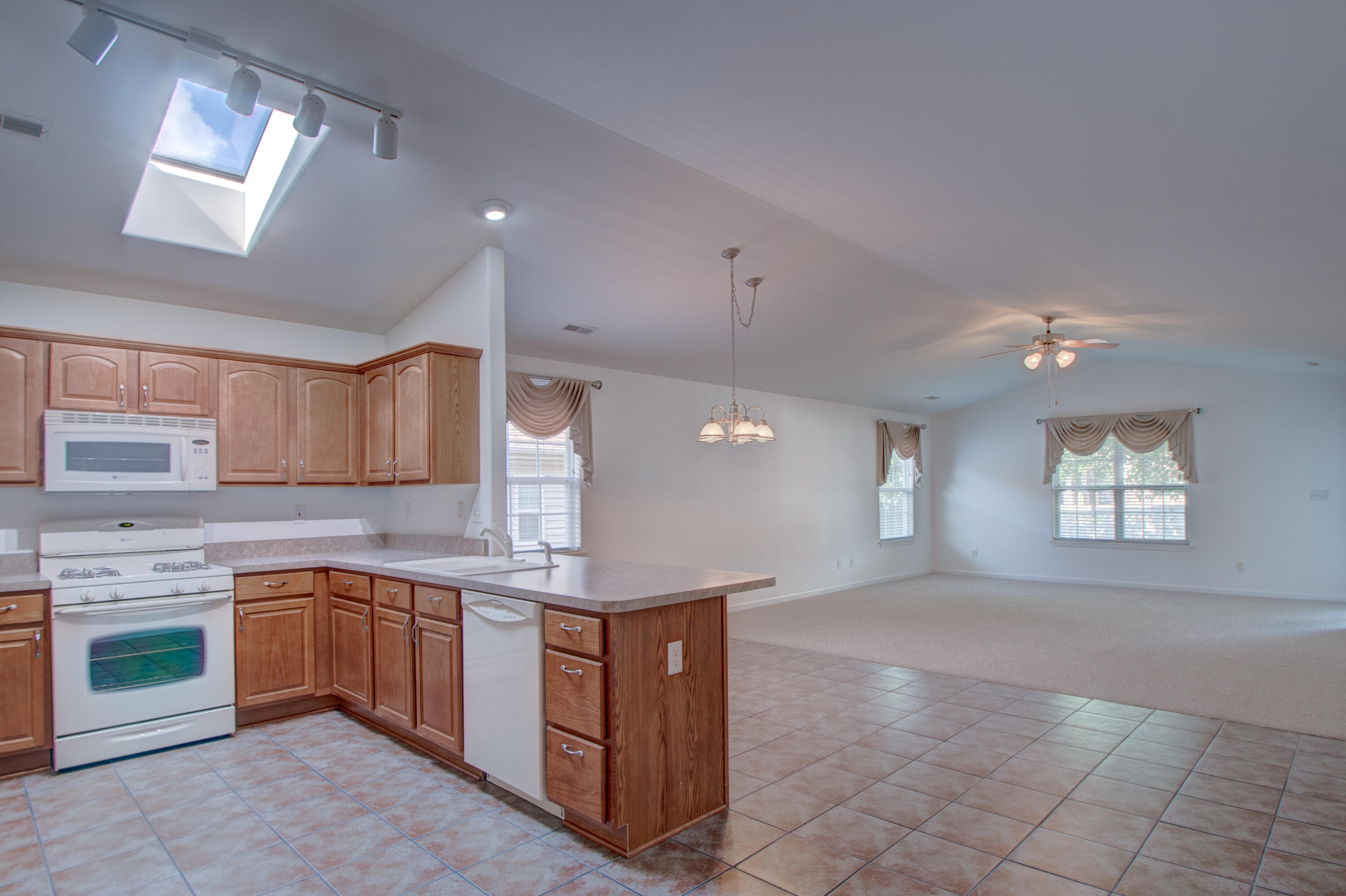 10677 Keystone Lane Crown Point, IN 46307 - Photo 7 of 33 a open kitchen with kitchen island a sink stainless steel appliances and cabinets