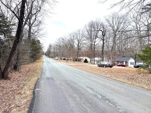 a view of road with a building and trees