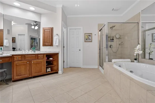 a spacious bathroom with a tub sink shower and mirror