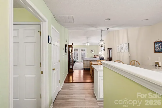 a view of a hallway with kitchen and refrigerator