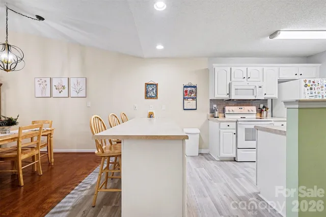 a bedroom with a bed dresser and a large window