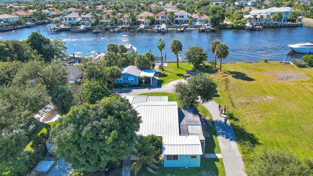 an aerial view of a house with a swimming pool and outdoor seating