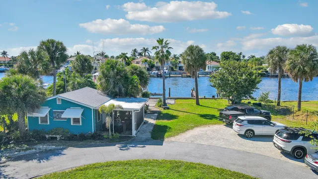 a view of a backyard with couches and swimming pool
