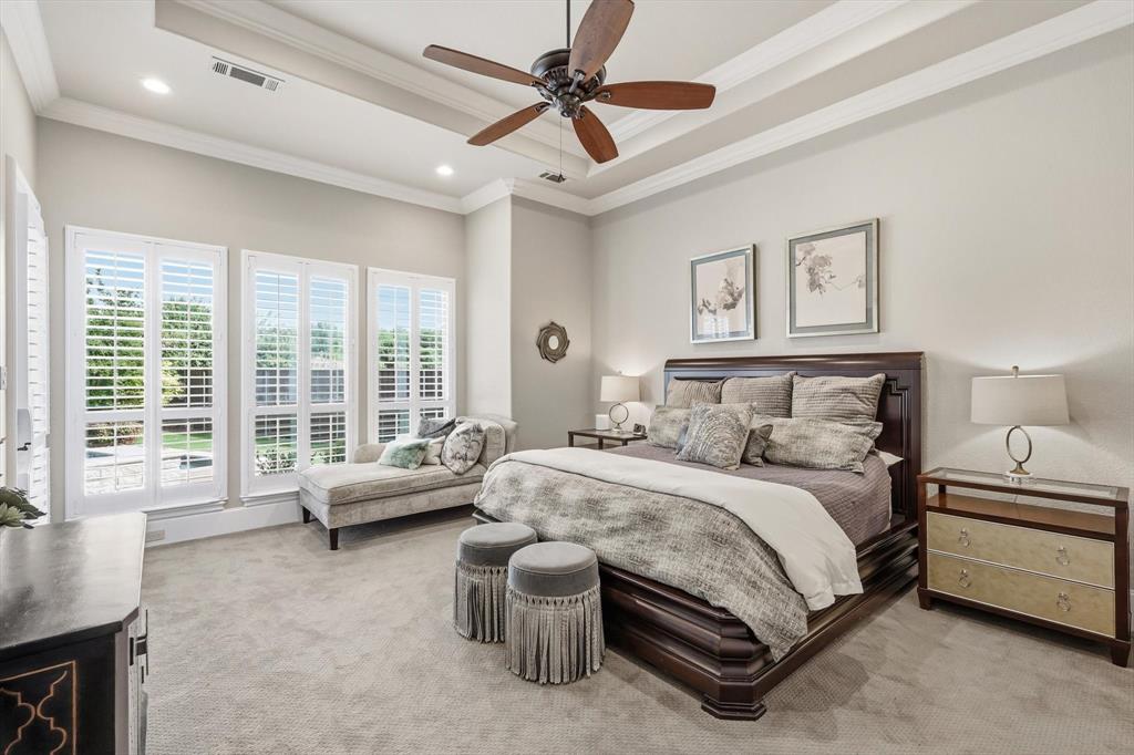 476 Hidden Valley Lane Coppell, TX 75019 - Photo 14 of 40 a spacious bedroom with a bed a couch and a ceiling fan