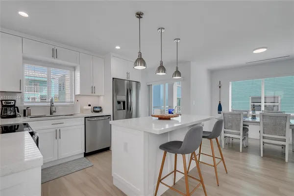 a large kitchen with a table and chairs