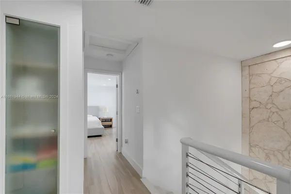 a bedroom with a bed and a view of kitchen