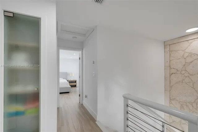 a bedroom with a bed and a view of kitchen