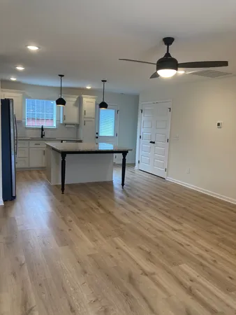 a room with wooden floor and furniture