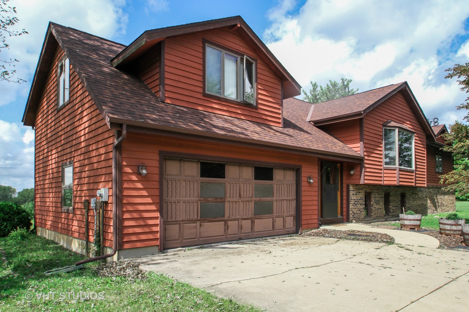14008 Davis Road Woodstock, IL 60098 - Photo 1 of 32 a front view of a house with a yard
