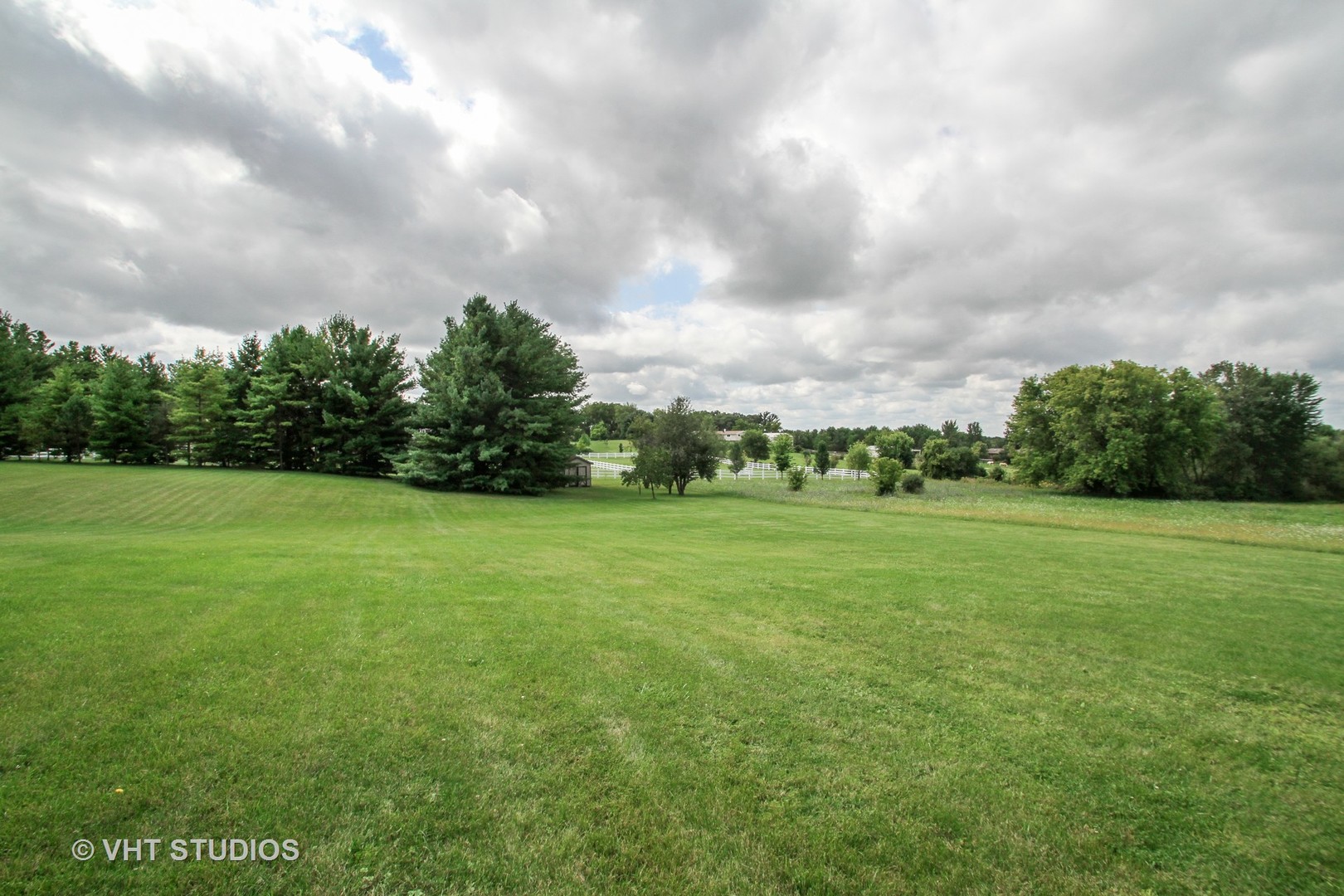 14008 Davis Road Woodstock, IL 60098 - Photo 23 of 32 a view of a green field with wooden fence