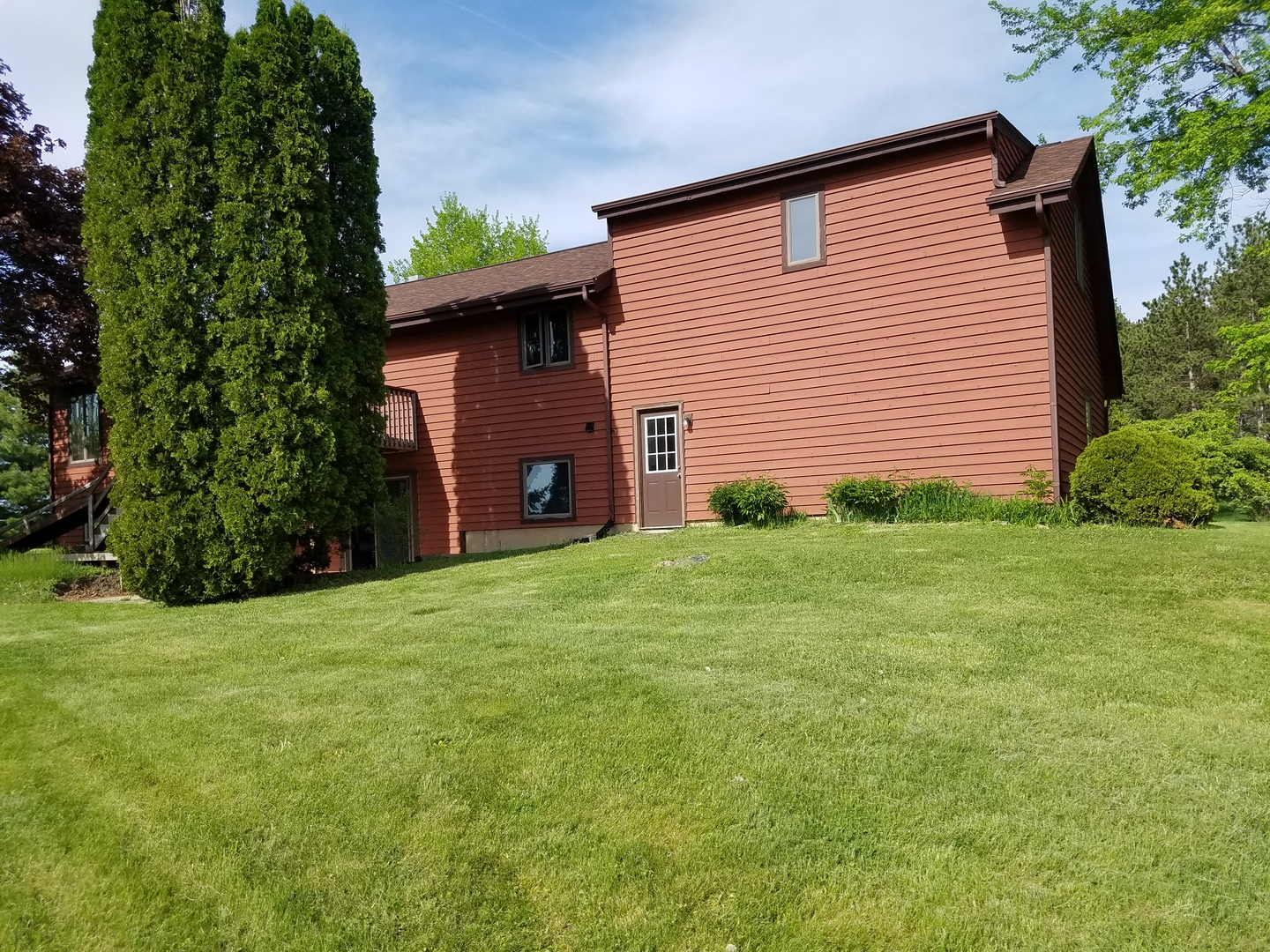 14008 Davis Road Woodstock, IL 60098 - Photo 26 of 32 a view of a backyard with potted plants and large tree