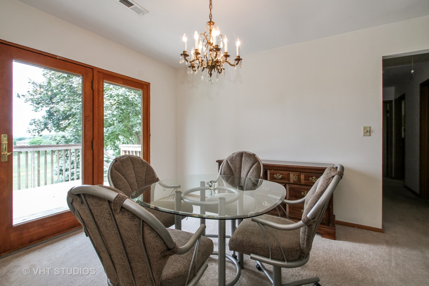 14008 Davis Road Woodstock, IL 60098 - Photo 5 of 32 a view of a dining room with furniture a chandelier and wooden floor