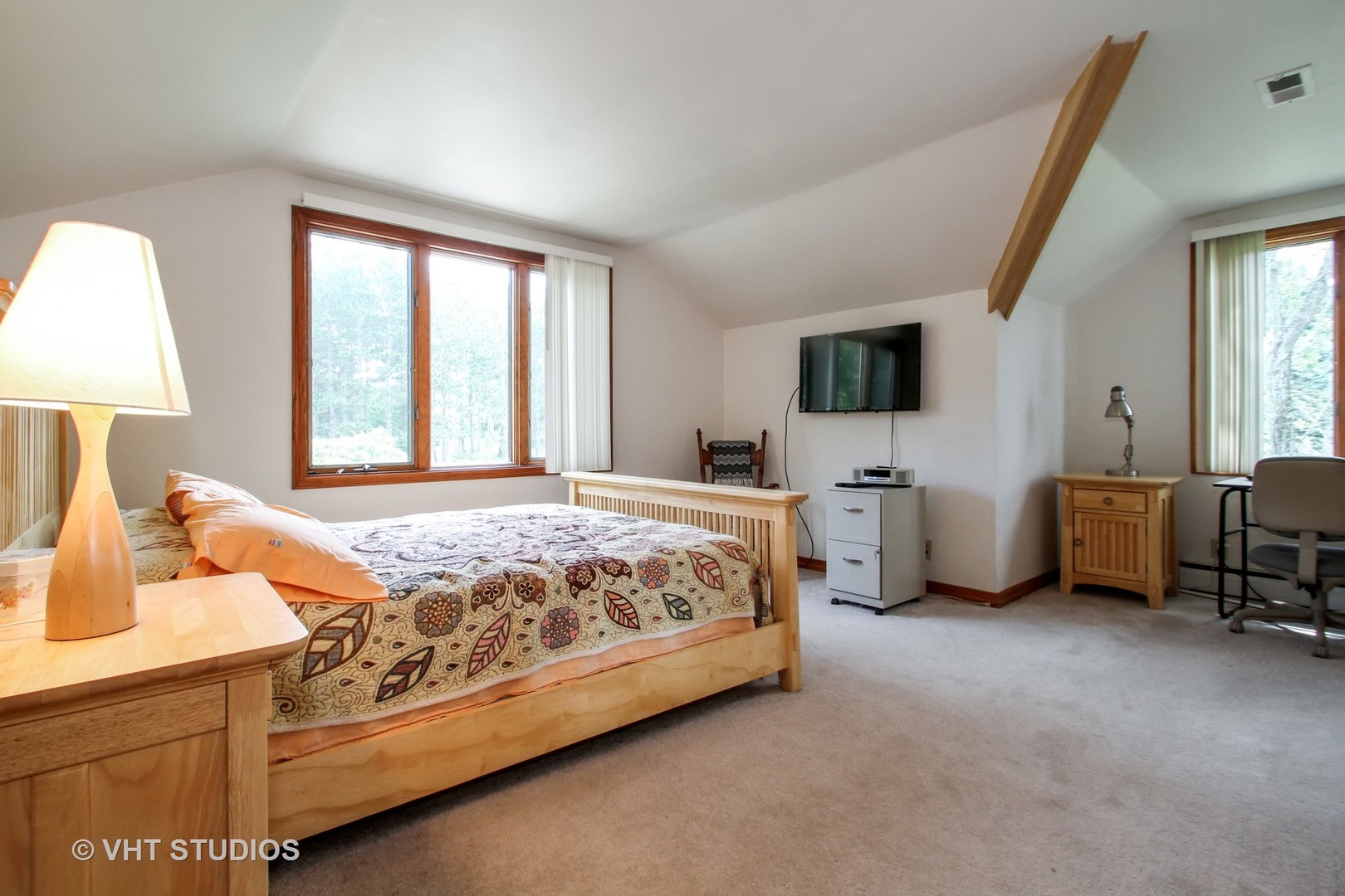 14008 Davis Road Woodstock, IL 60098 - Photo 6 of 32 a spacious bedroom with a bed and a table in it
