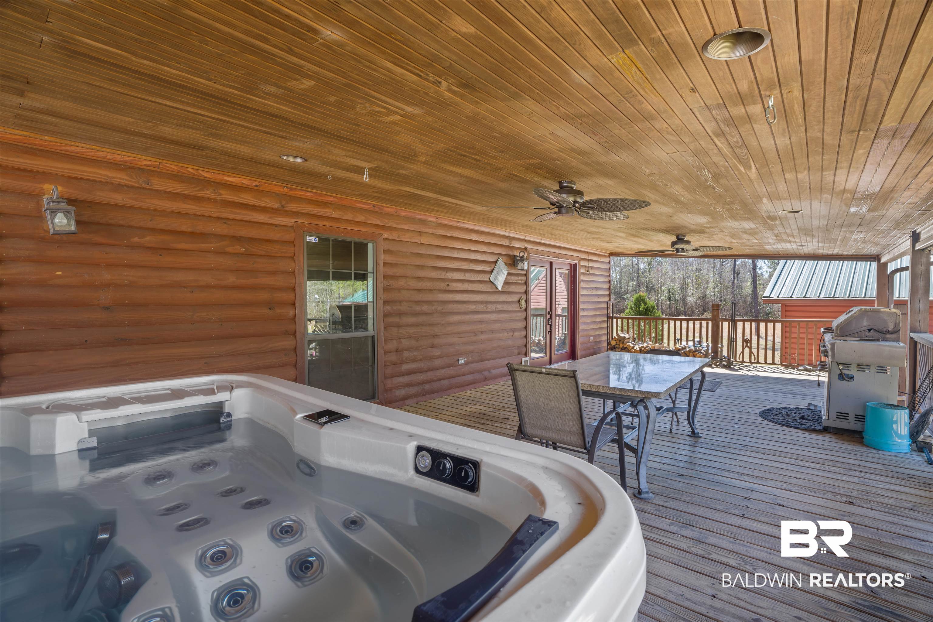 51699 Highway 31 Perdido, AL 36562 - Photo 6 of 30 Deck featuring area for grilling, outdoor dining space, a jacuzzi, and a ceiling fan