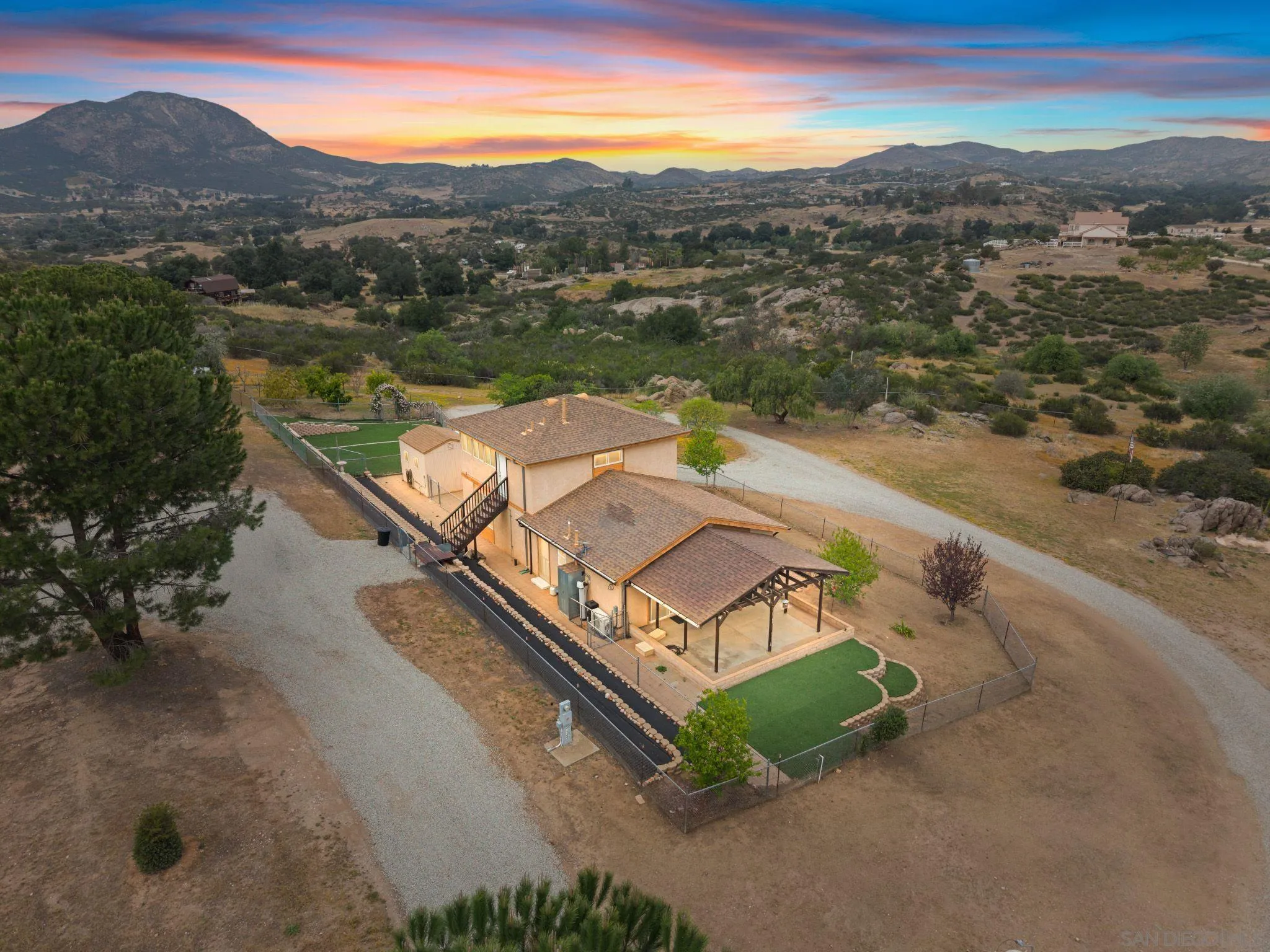 39260 Grassy Road Temecula, CA 92592 - Photo 1 of 1 an aerial view of a house with a yard and lake view