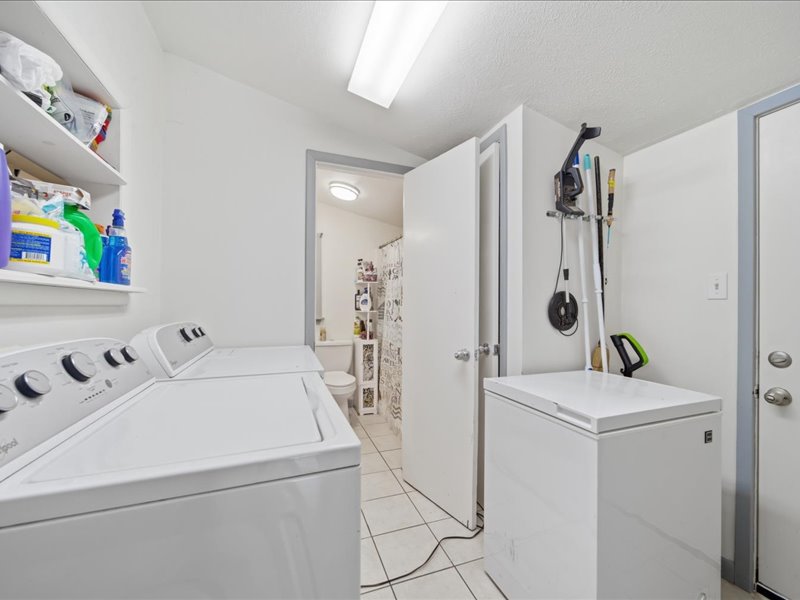 600 South Main Street Spavinaw, OK 74366 - Photo 20 of 42 Utility room with tiled flooring, overhead lighting, and built-in shelving