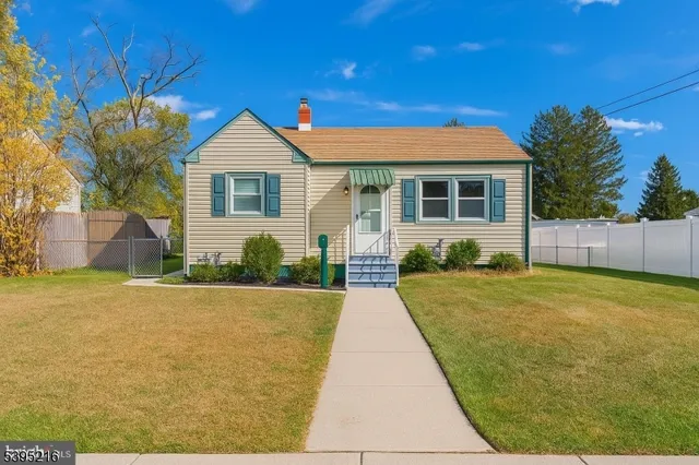 a front view of house with yard and trees