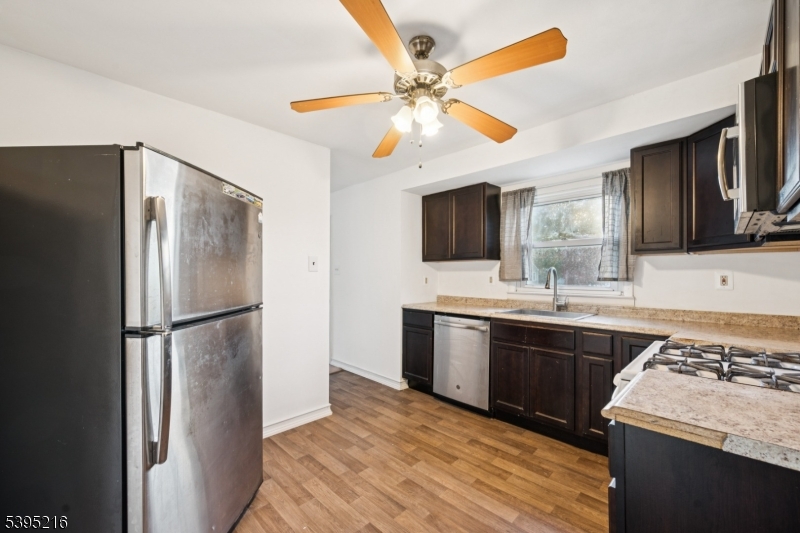 610 Lee Avenue Beverly, NJ 08010 - Photo 12 of 21 a kitchen with stainless steel appliances granite countertop a refrigerator a oven a sink with a dining table and chairs