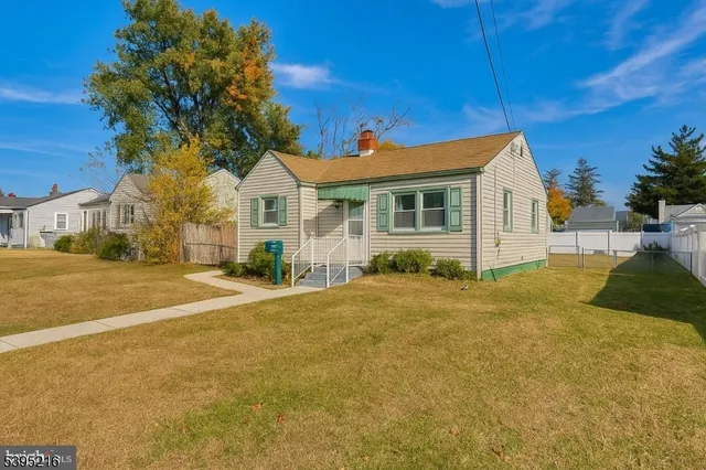 a view of a house with a yard and garage